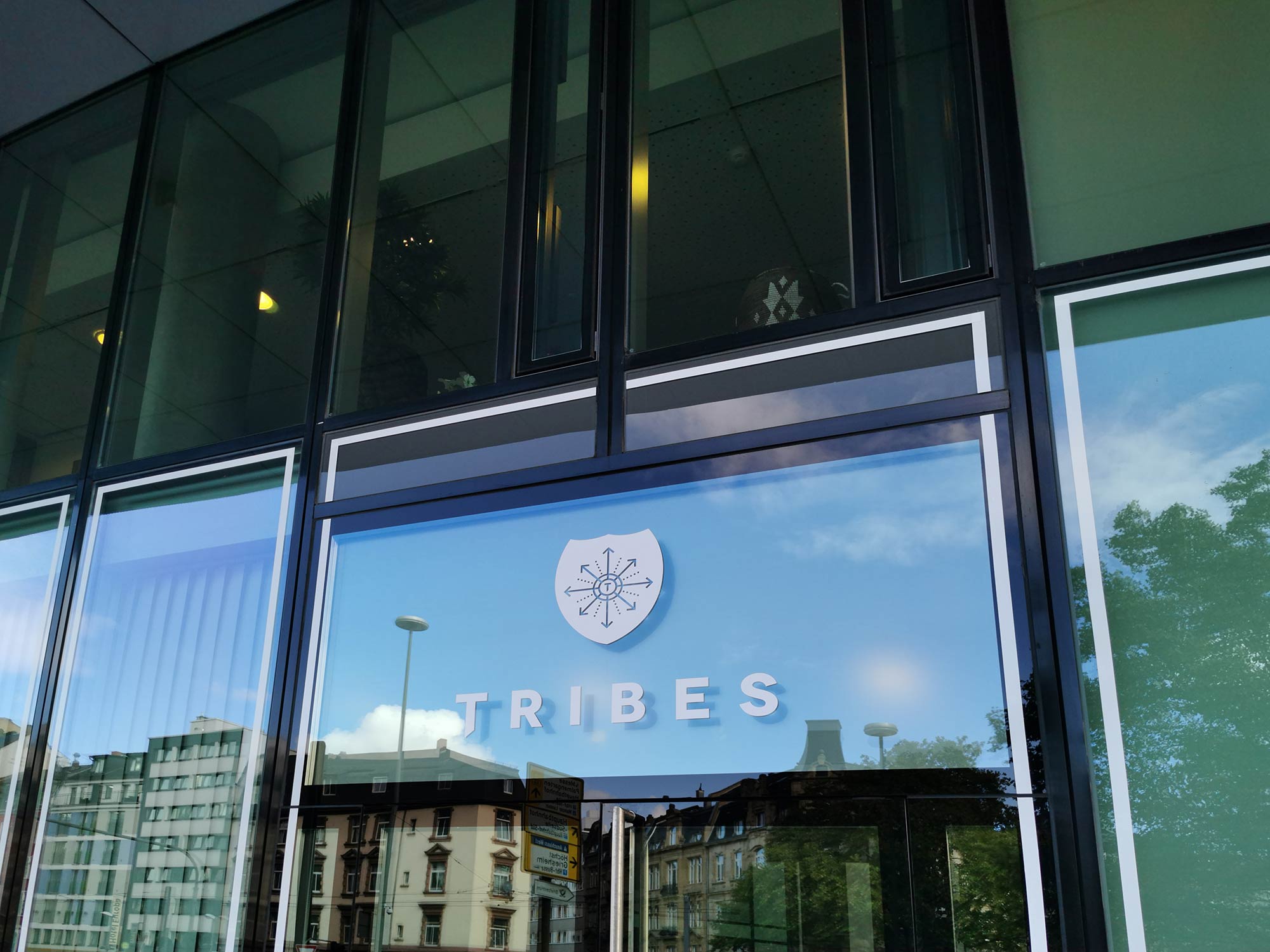 Tribes logo at the facade of an office building - rental coworking offices